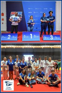 Montagem com duas fotos de pódio e equipe de competição em tatame vermelho.
Na foto de cima, há três pessoas em um pódio azul com números 2, 1 e 3 na frente, sobre um tatame vermelho. Ao fundo, um painel azul com várias logomarcas: “CBDV” se repete diversas vezes; mais à esquerda aparece “GARANTIA DA VITÓRIA” em vermelho e branco; mais à direita há outras marcas menores, que parecem dizer “CAIXA” e mais textos pequenos não legíveis.
Sobre o degrau 2, à esquerda, está uma pessoa de pele parda, cabelo curto escuro, vestindo camisa clara com detalhes em vermelho e preto e calça escura, segurando um troféu retangular azul.
No centro, sobre o degrau 1, está uma pessoa de pele clara, cabelo castanho preso, usando camiseta azul e calça jeans, também segurando um troféu azul.
À direita, sobre o degrau 3, estão duas pessoas de pele morena: uma com cabelo comprido preso, usando camiseta azul marinho com a palavra “NAURU” em branco, e calça jeans; a outra com cabelo crespo volumoso, camiseta azul escura com estampa clara no peito e calça escura, ambas segurando um troféu azul.
Na foto de baixo, há um grande grupo de pessoas posando sobre o mesmo tipo de tatame vermelho. A maioria veste quimono branco com faixas na cintura ou camisa azul royal com detalhes em branco e vermelho. Alguns estão em pé atrás; outros estão agachados ou sentados à frente. No centro, uma pessoa mais velha segura o mesmo tipo de troféu azul. Alguns atletas usam medalhas penduradas no pescoço. Ao fundo há um telão aceso e cortinas escuras.
No canto inferior esquerdo da foto de baixo há um logo branco com um desenho estilizado azul e o texto:
“CBCP
CLUBE
APOIADO”.